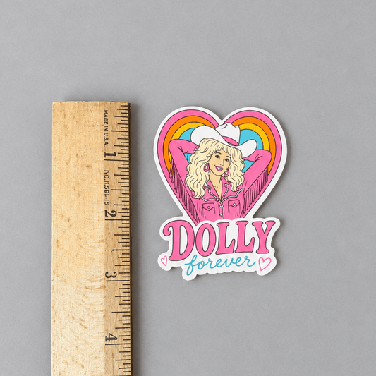 Dolly sticker and ruler on muted light grey background with a ruler