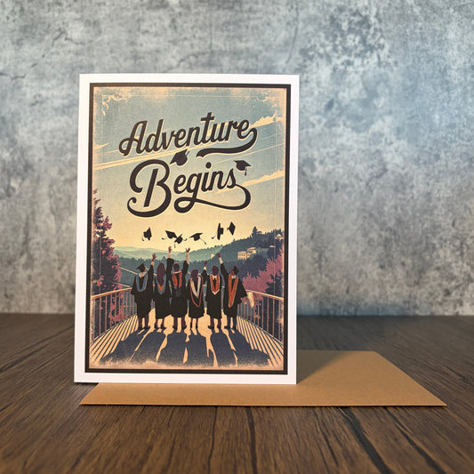Impish Greetings graduation card featuring graduates throwing caps with the text The Adventure Begins and kraft envelope