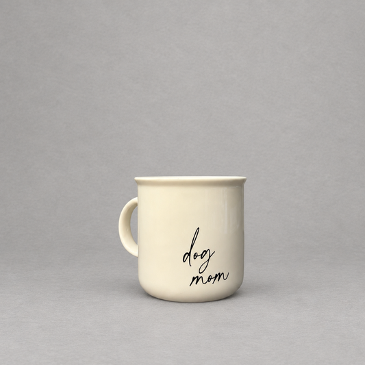 Impish Greetings 11 oz cream ceramic campfire-style coffee mug with black script text reading dog mom