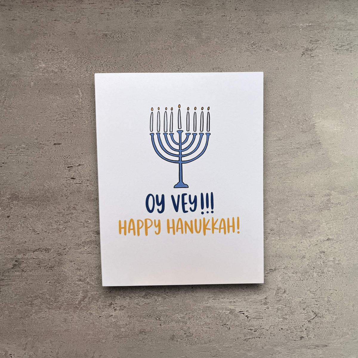 Impish Greetings Hanukkah card featuring a blue menorah illustration with the text Oy Vey and Happy Hanukkah