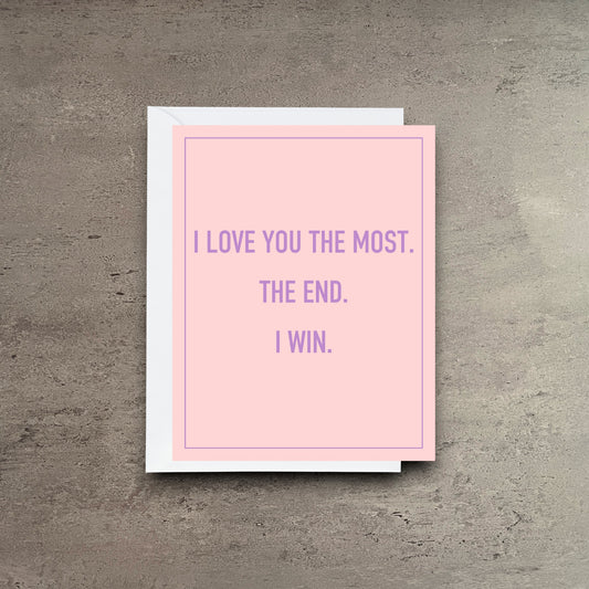 Impish Greetings I Love You The Most greeting card with purple text on a light pink background and white envelope.