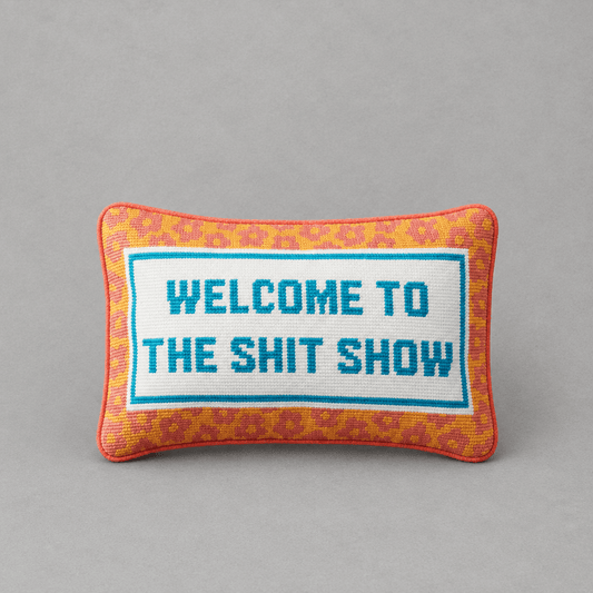 Impish Greetings needlepoint throw pillow with Welcome To The Shit Show text, orange leopard print, and blue border.