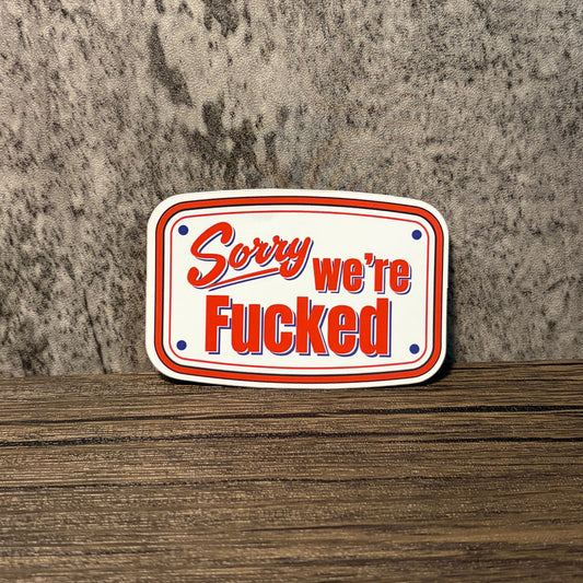 Impish Greetings Sorry We're Fucked die-cut vinyl sticker with red and blue typography on a white background
