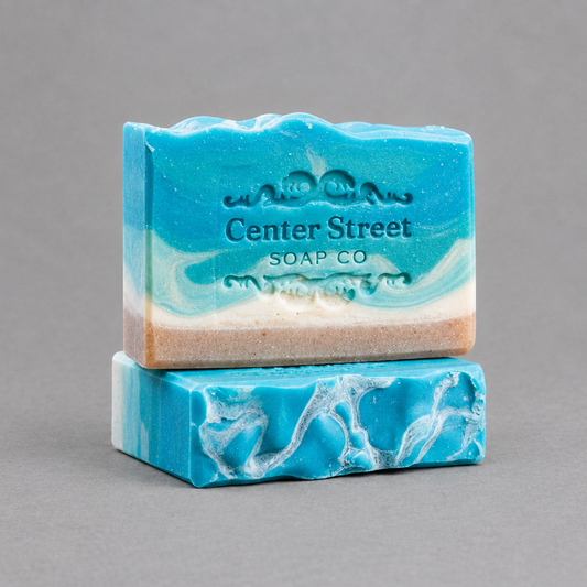 Impish Greetings Summer Cottage artisan soap bars with blue and white coastal swirl patterns on a grey background