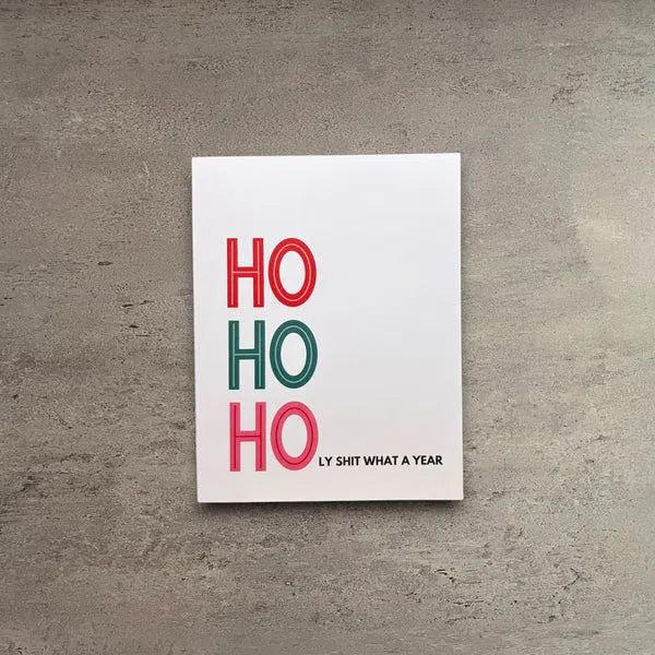 Ho Ho Holy Shit What A Year Christmas card in a vintage-inspired flat lay
