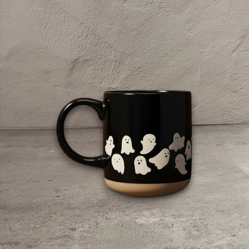 Impish Greetings black stoneware coffee mug featuring a cute white ghost pattern and a natural base