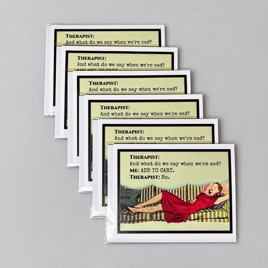 A fan of printed cards laid on a textured gray surface. The cards have cream backgrounds with black text and a small illustration of a person in a red dress near the bottom.