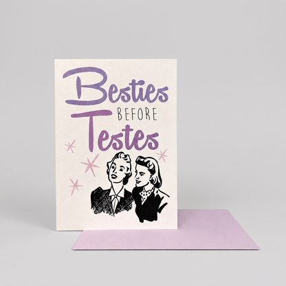 Besties Before Testes card and lavender envelope on a lighter muted-grey background