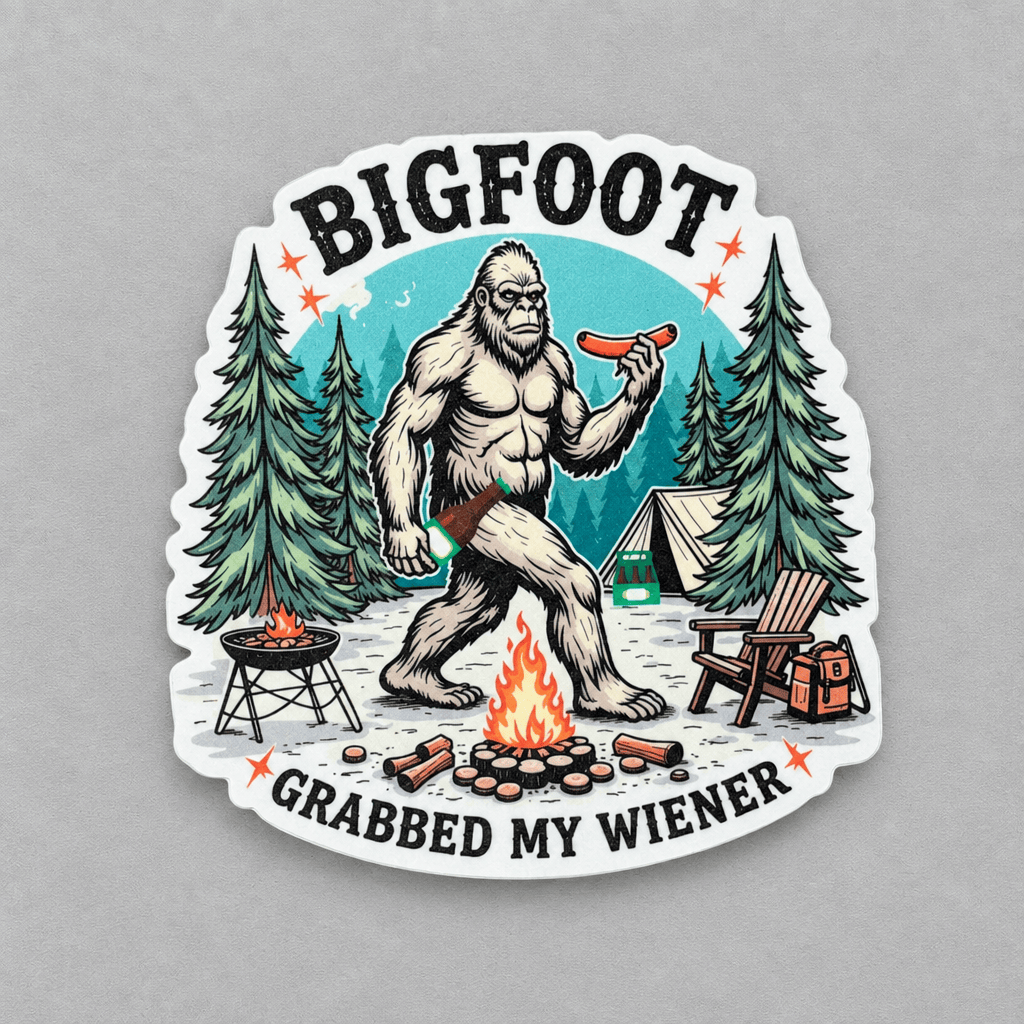 A die-cut vinyl sticker featuring a cartoon Bigfoot holding a hot dog in a camping scene with the text 'BIGFOOT GRABBED MY WIENER', shown on a neutral gray background.