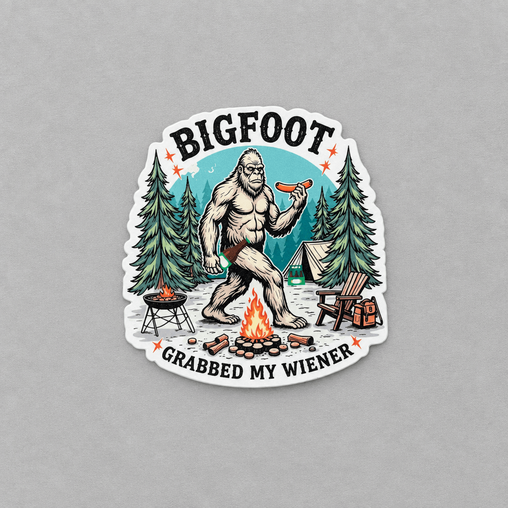 A die-cut vinyl sticker featuring a cartoon illustration of Bigfoot holding a hot dog, surrounded by camping elements like a campfire, grill, tent, and chair, with the text 'BIGFOOT GRABBED MY WIENER' on a light gray background.