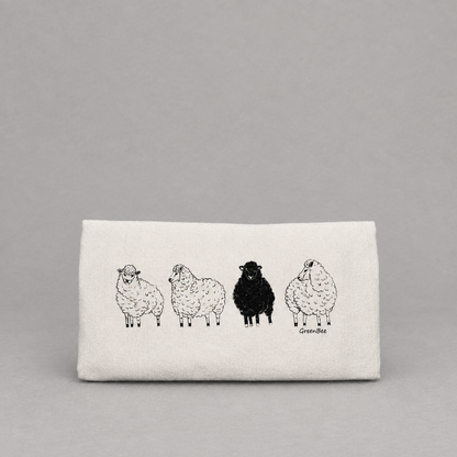 Black Sheep Dish Tea Towel on a light grey background