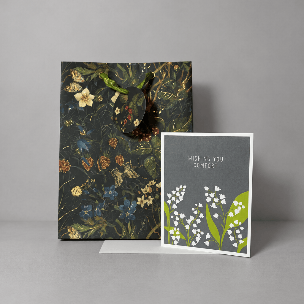 Card and gift bag on a muted light-grey background