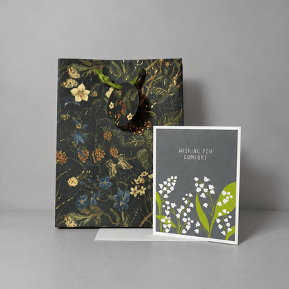 Card and gift bag on a muted light-grey background