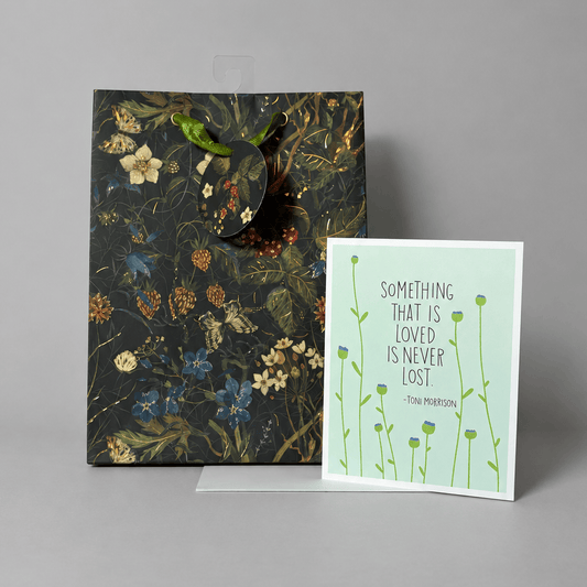 Card and gift bag on muted light grey