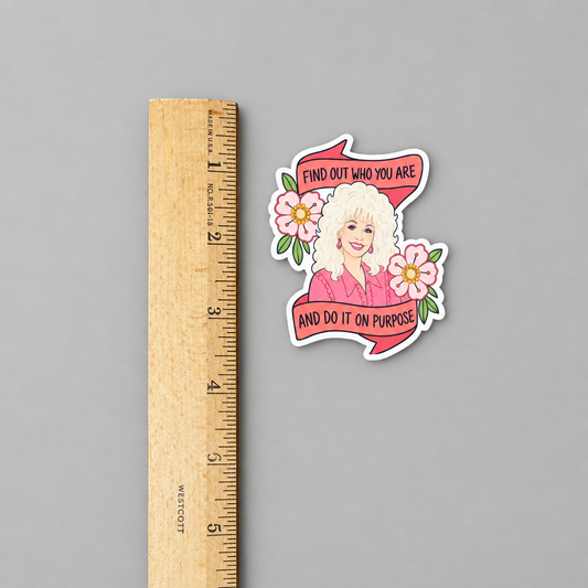Dolly quote sticker against a light grey background with a ruler to show dimensions
