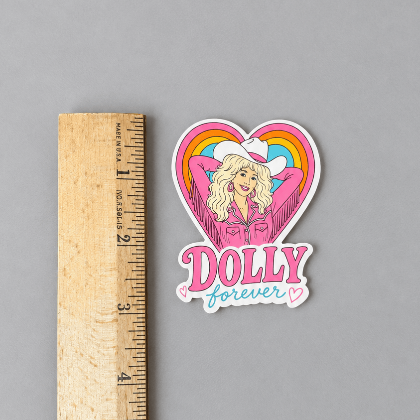 Dolly sticker and ruler on muted light grey background with a ruler