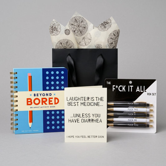 Feel Better, Dammit Gift Kit with plain black ribbon-handle bag and patterned tissue on muted light grey
