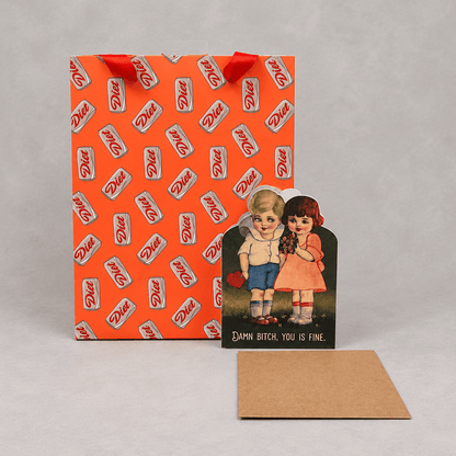 Gift bag, card and envelope on muted light-grey background