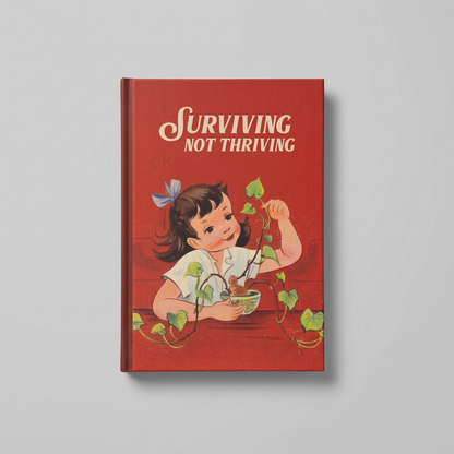 Alternate flat lay of Surviving Not Thriving notebook on muted light grey background