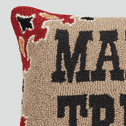 Close-up of Mama Tried pillow wool hook texture and red border on light grey