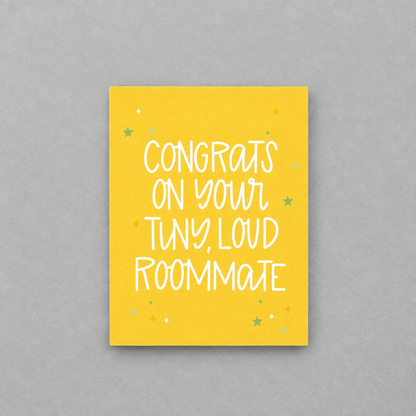 Impish Greetings baby congratulations card with yellow background and white text reading Congrats on Your Tiny Loud Roommate