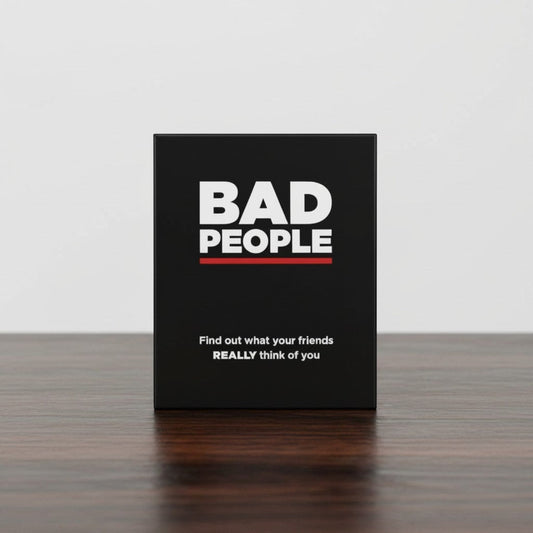 Impish Greetings Bad People adult party card game box in black with white text on a wooden table