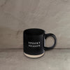 Impish Greetings black stoneware coffee mug with Spooky Season text in white, featuring a natural base.