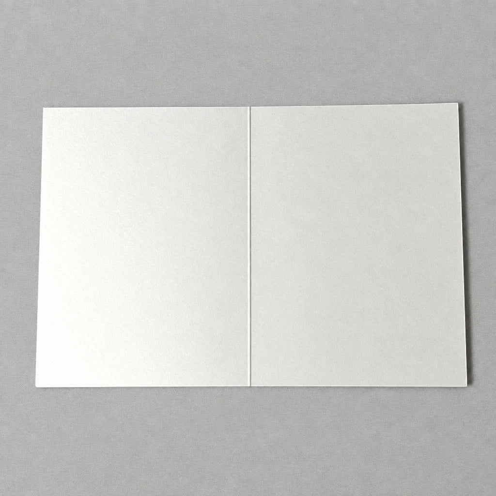 Impish Greetings blank A2 greeting card on thick white cardstock, shown open on a neutral grey background.