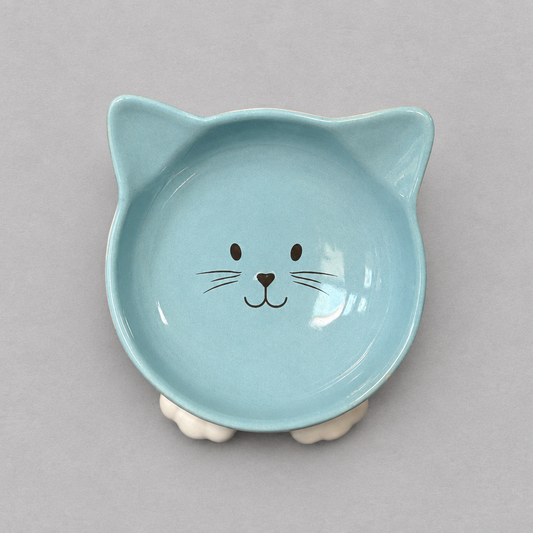Impish Greetings blue ceramic cat-shaped bowl with a cute face design and tilted base for improved pet posture.