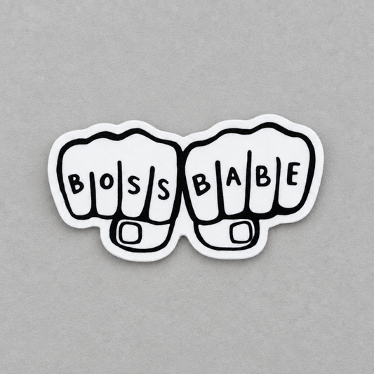 Impish Greetings Boss Babe sticker featuring two white fists with black outlines and lettering on a grey background.