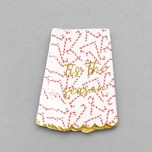 Impish Greetings candy cane print paper guest towels with gold foil text and scalloped edges for holiday decor.