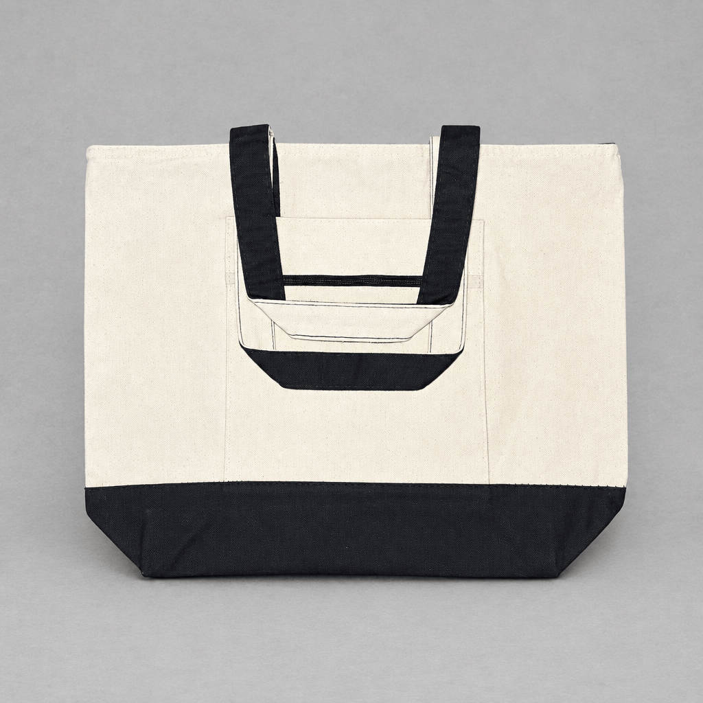 Impish Greetings heavy cotton canvas tote bag in cream with black handles, base, and front zipper pocket.