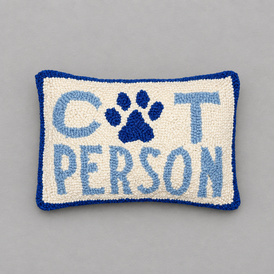 Impish Greetings Cat Person hook pillow in cream and blue wool with a paw print design on a grey background.