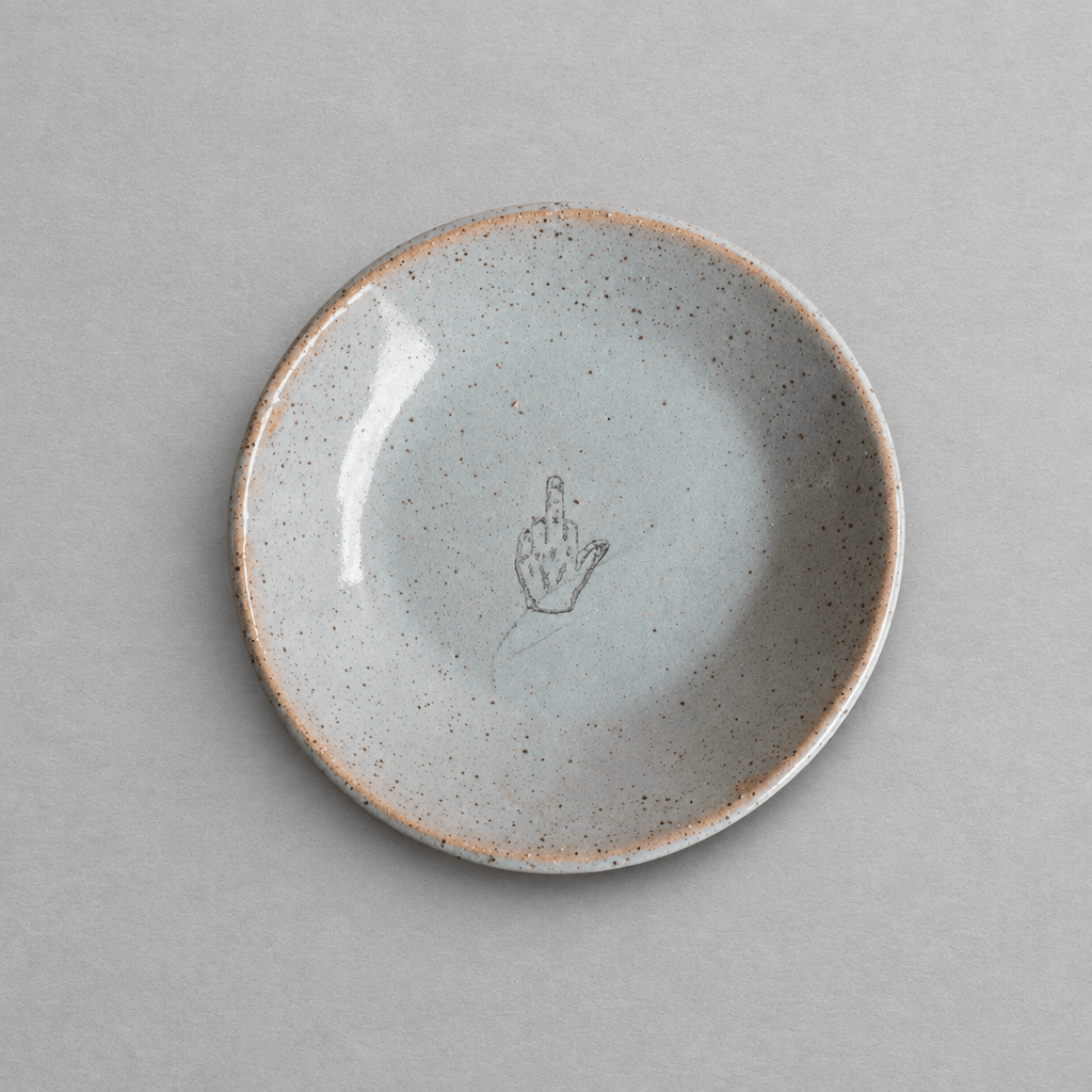 Impish Greetings handcrafted ceramic mini plate with a speckled glaze and a middle finger illustration.