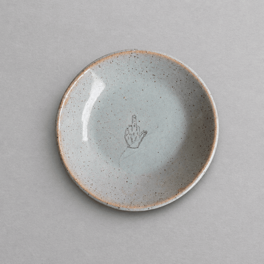 Impish Greetings handcrafted ceramic mini plate with a speckled glaze and a middle finger illustration.