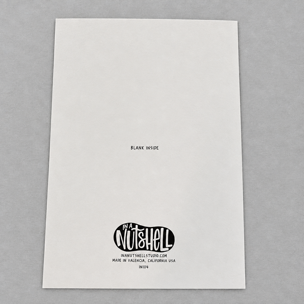 Back of an Impish Greetings 5x7 inch greeting card featuring the In A Nutshell Studio logo on white card stock