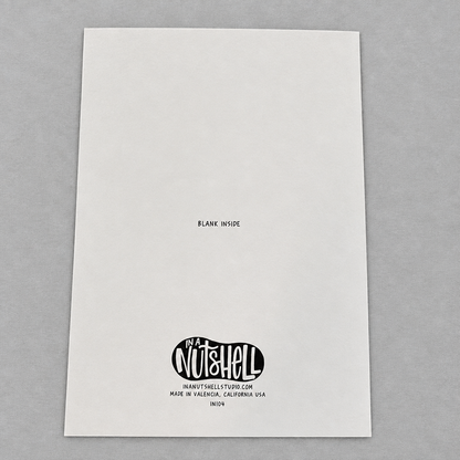 Back of an Impish Greetings 5x7 inch greeting card featuring the In A Nutshell Studio logo on white card stock