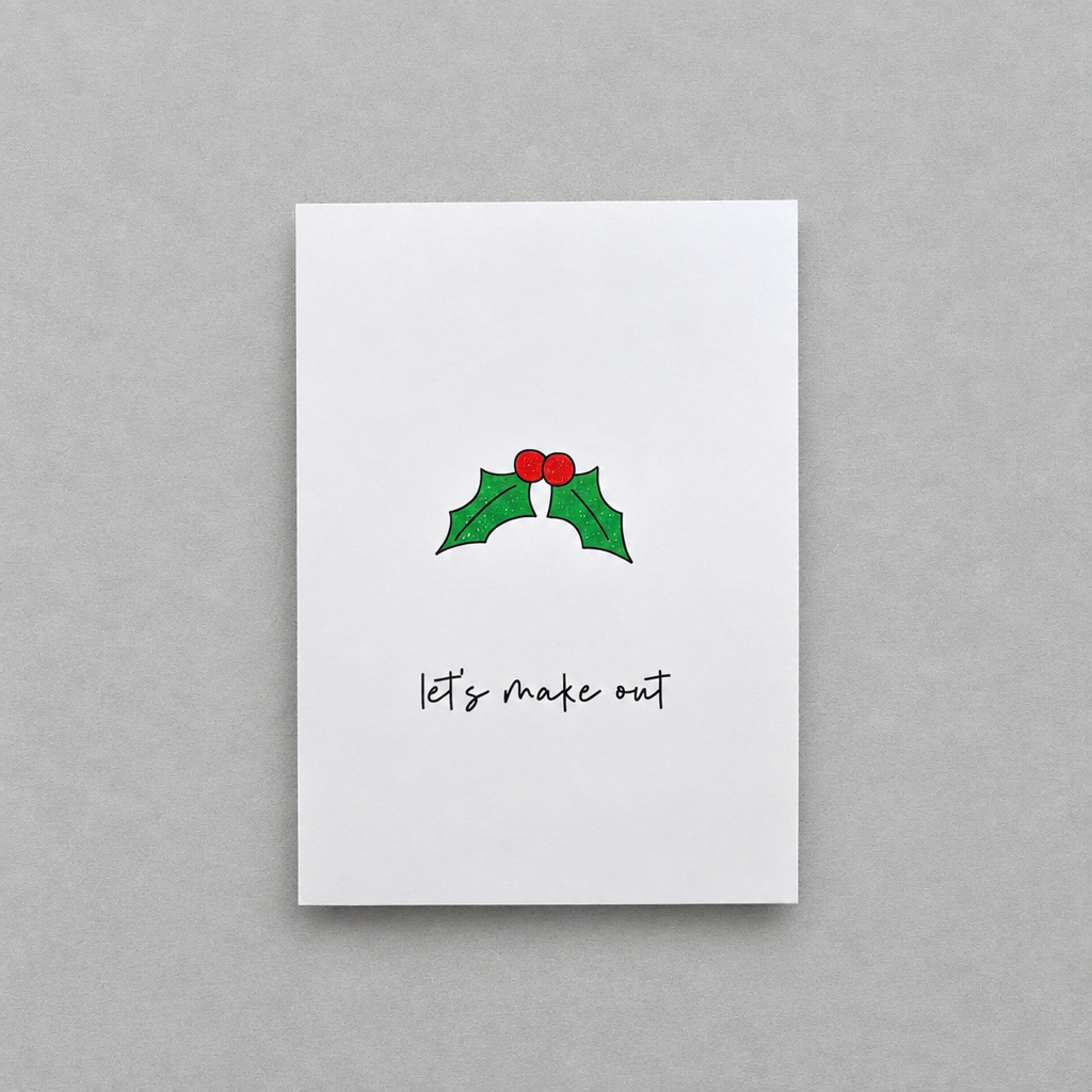 Impish Greetings Christmas card with holly illustration and the text Let's make out on white matte card stock