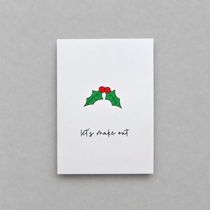 Impish Greetings Christmas card with holly illustration and the text Let's make out on white matte card stock