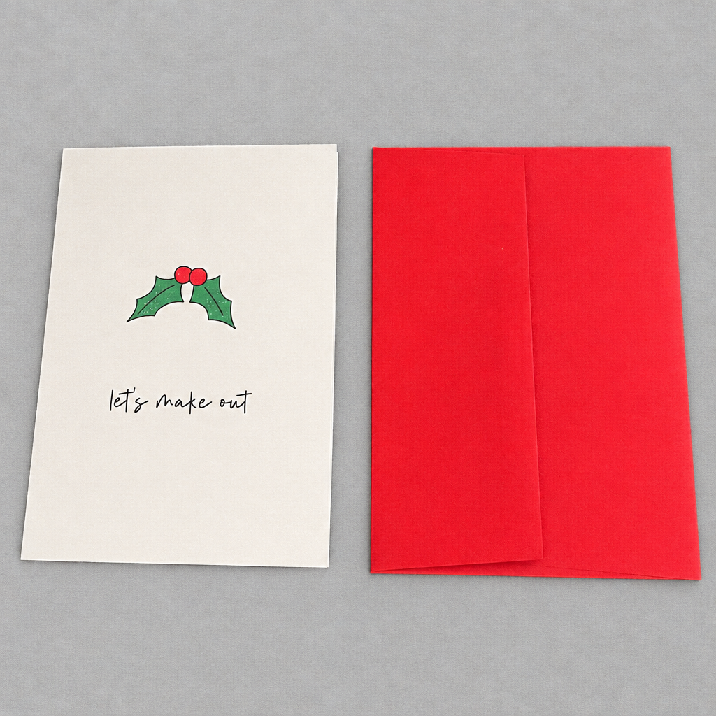 Impish Greetings Christmas card with holly illustration and Let's Make Out text, paired with a bright red envelope.