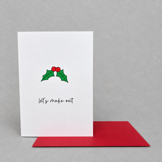 Impish Greetings Christmas card with holly illustration and Let's Make Out text, featuring a red envelope.