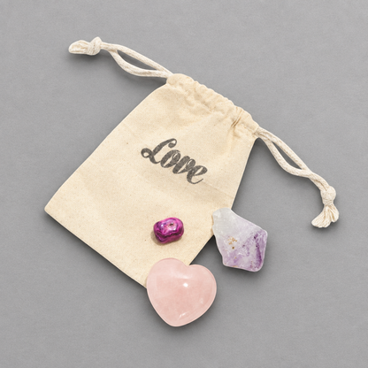 Impish Greetings LOVE + HAPPINESS crystal set featuring rose quartz heart, amethyst point, and agate in a pouch.