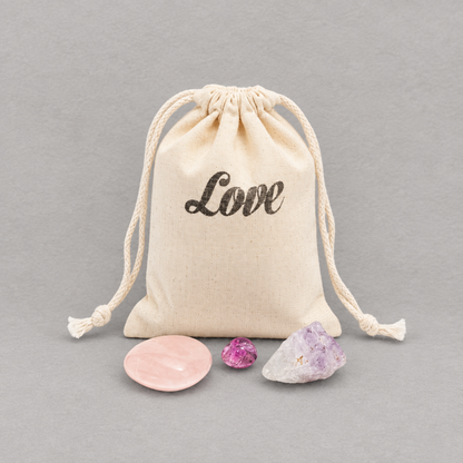 Impish Greetings crystal gift set featuring rose quartz, amethyst, and agate stones with a Love drawstring pouch.
