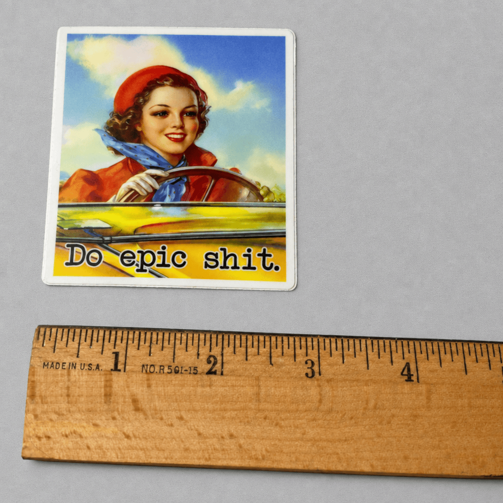 Impish Greetings Do Epic Shit vinyl sticker featuring a vintage-style woman driving a yellow car with matte finish.