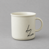 Impish Greetings 11 oz cream ceramic campfire-style coffee mug with black cursive Dog Mom text on a grey background