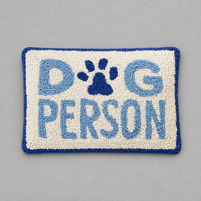 Impish Greetings Dog Person rectangular hooked wool rug with blue and cream textured lettering and a paw print