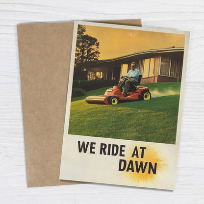 Impish Greetings We Ride At Dawn Father's Day card featuring a vintage lawn mower illustration and kraft envelope.