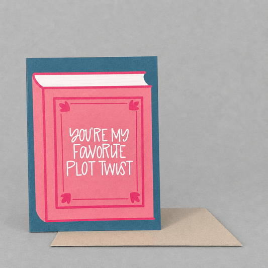Impish Greetings Favorite Plot Twist Valentine card featuring a pink book illustration on a blue background