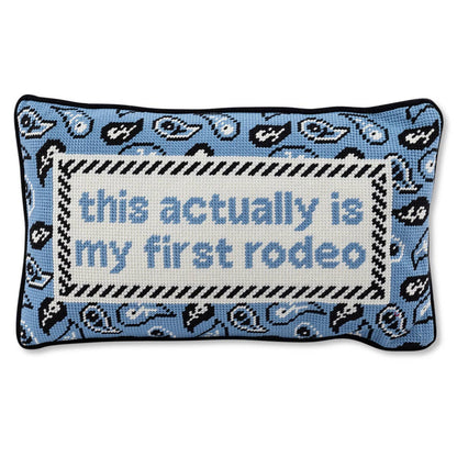 Impish Greetings First Rodeo needlepoint pillow with blue paisley pattern and black and white striped border.