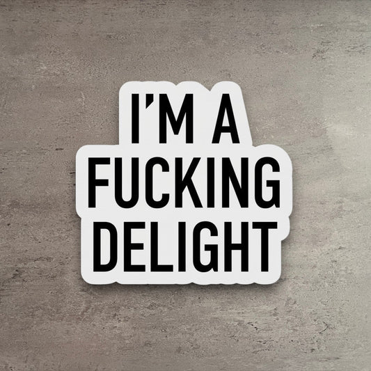 Impish Greetings vinyl sticker featuring the bold black text I'm a Fucking Delight on a white matte background.